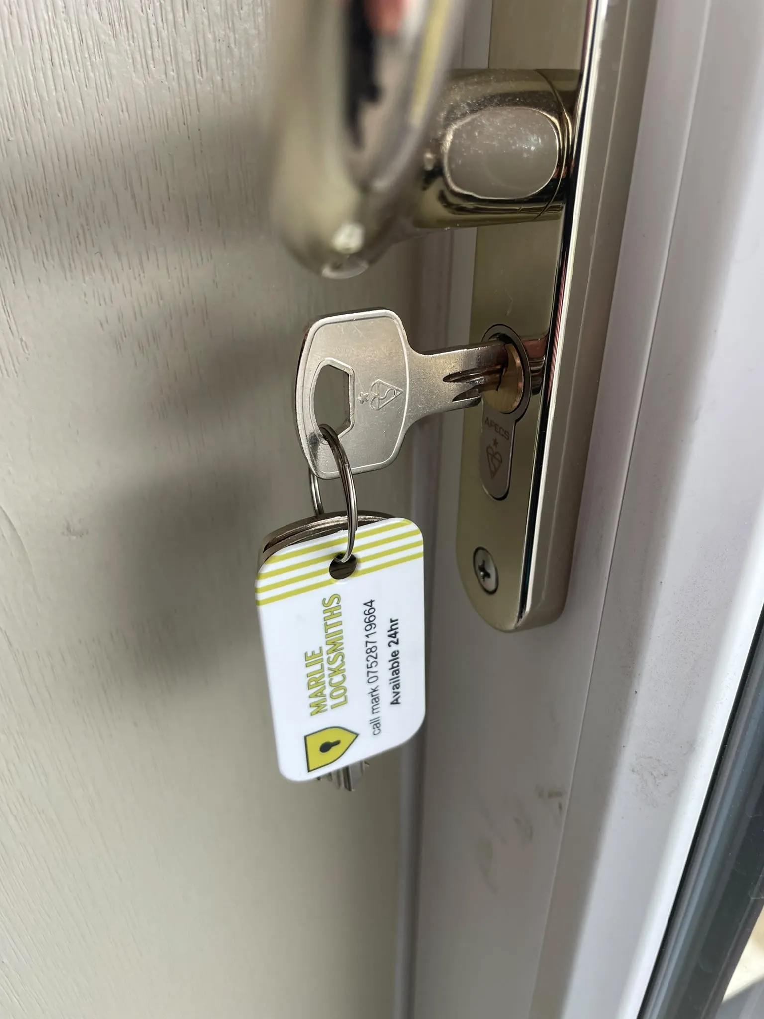 Emergency locksmith using non-destructive lock picking tools to open a front door